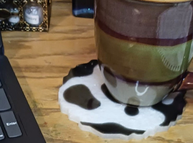 Cow print coasters designed for protecting surfaces while adding style to your home decor
