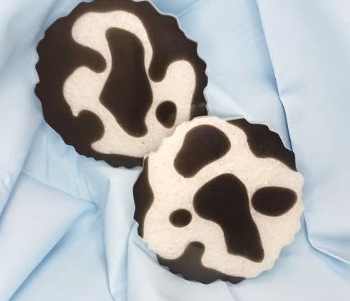 Set of stylish cow print coasters featuring a unique black and white design for home decor