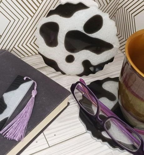 Stylish cow print coasters in black and white, perfect for drinks and home decor